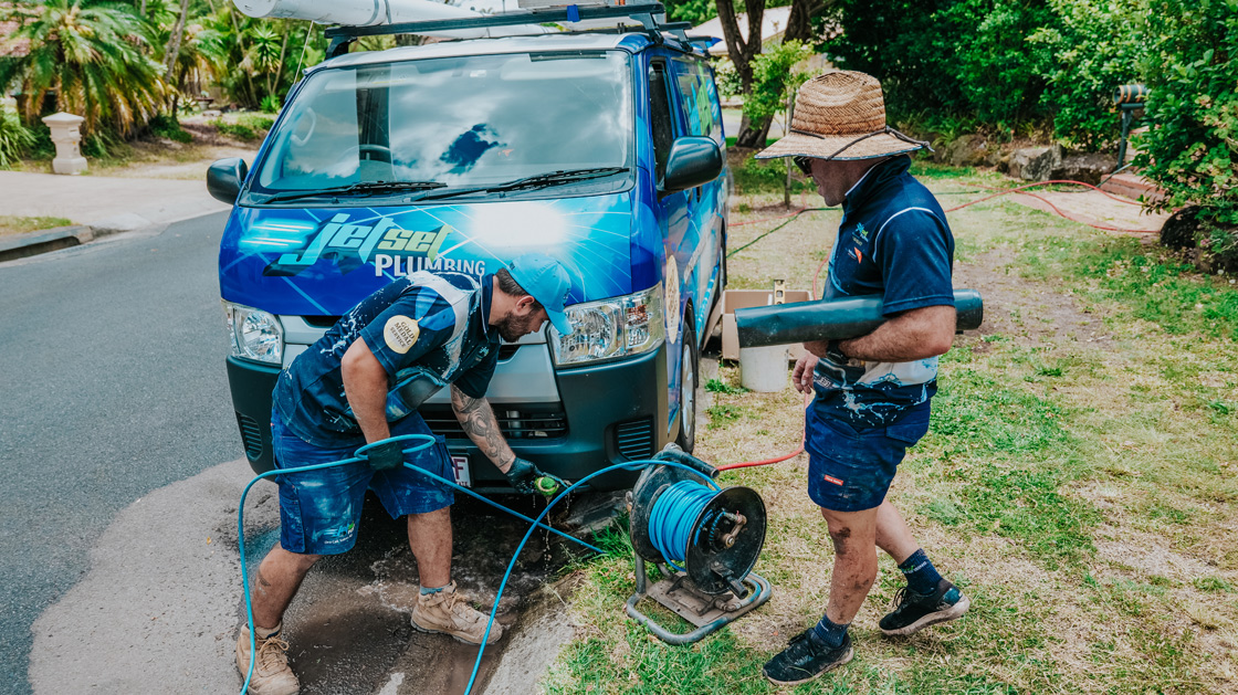 Plumber clearing a drain - Blocked Drains Sydney